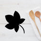 Black leaf decal with curved stem