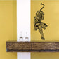 Leaping tiger turning wall decal in black on yellow background