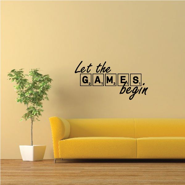 Black tile-style wall decal reading "Let the Games begin"