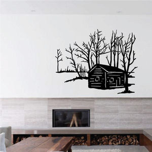 Black log cabin wall decal with leafless trees and stone chimney