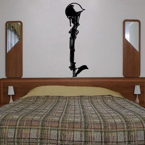 Black cross wall decal with small dove silhouette, centered above bed