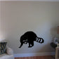 Black raccoon looking-over decal with striped tail on wall