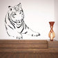 Lounging tiger wall decal with black line art on light background