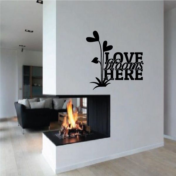 Floral wall decal with black 'LOVE BLOOMS HERE' lettering and flower icons