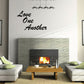 Black script wall decal reading “Love One Another”
