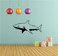 Black shark silhouette wall decal with fin and tail, facing left