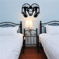 Ram head wall decal with black and white horns above a bed