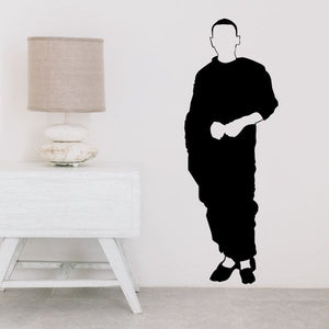 Male monk decal silhouette holding a guitar