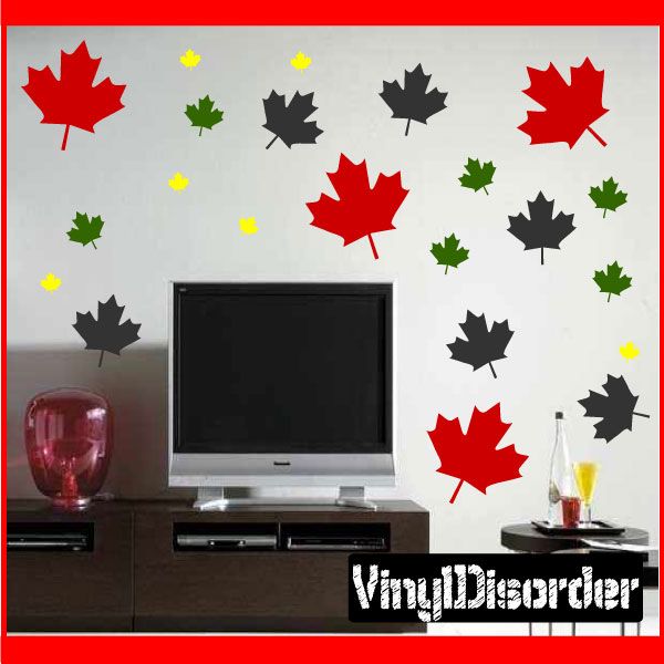 Maple leaf wall decal set with red, green, and black fall leaves on a wall