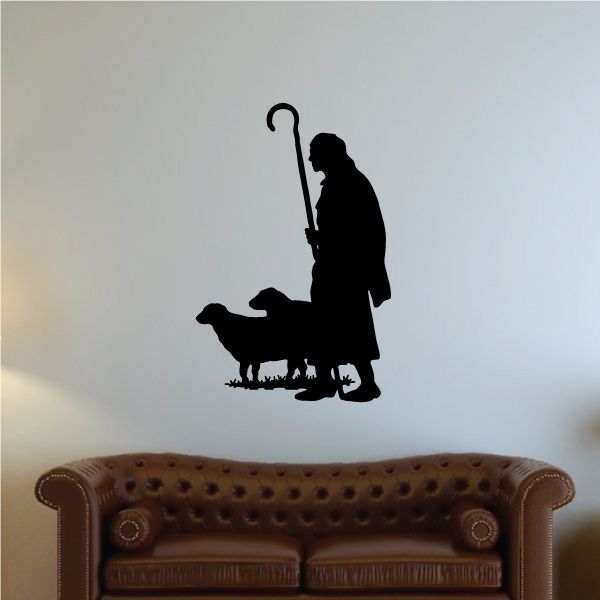 Religious wall decal of a kneeling shepherd holding a staff with a sheep