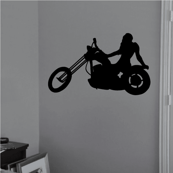 Motorcycle wall decal: black vinyl silhouette of rider on motorcycle.