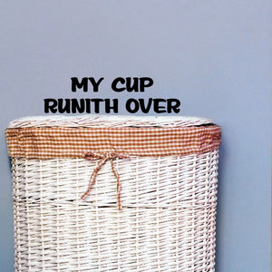 Vinyl decal with 'My Cup Runith Over' text on a striped surface