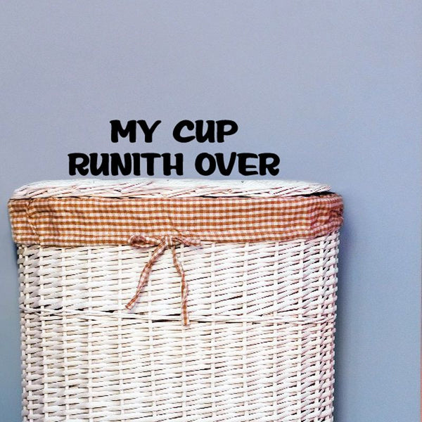 Vinyl decal with 'My Cup Runith Over' text on a striped surface