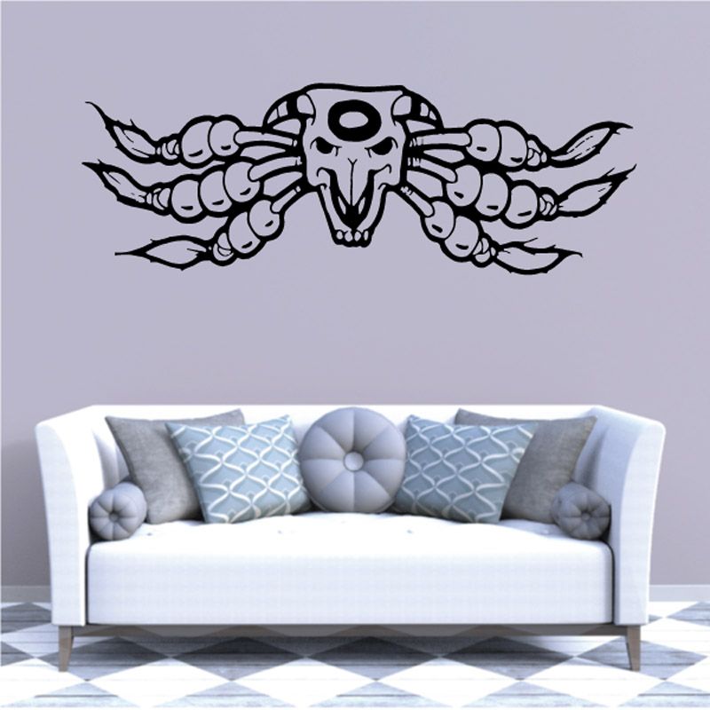 Wall decal featuring black skull with wings and bead-like details