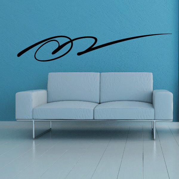 Southwestern vinyl wall decal with black swirl motif on blue wall above sofa