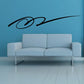 Southwestern vinyl wall decal with black swirl motif on blue wall above sofa