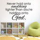 Inspirational wall decal with black quote text: “Never hold onto anything tighter than you’re holding onto God.”