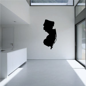 New Jersey state decal, black state silhouette on a light wall