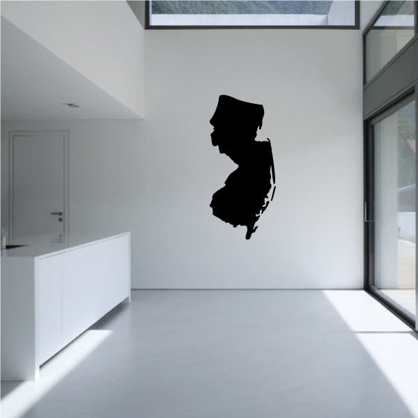New Jersey state decal, black state silhouette on a light wall