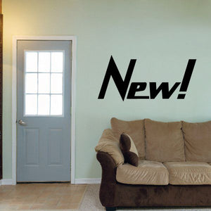 Vinyl wall decal reading “New!” in black