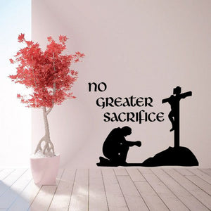 Religious wall decal with silhouetted cross, praying figure, and text "no greater sacrifice".
