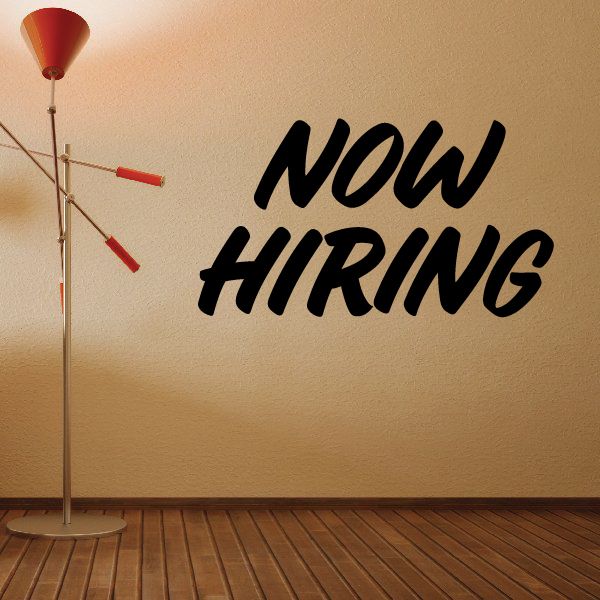 Wall decal reading 'Now HIRING' in bold black letters