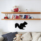 Black squirrel wall decal with bushy tail and curled pose
