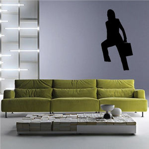 Vinyl wall decal of a black silhouette of a seated businesswoman holding a briefcase