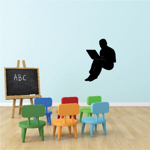 Wall decal: black silhouette of person sitting and reading with open book