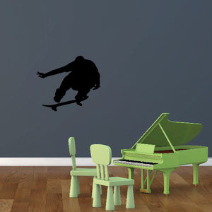 Skateboarding wall decal of a black skateboarder doing an airborne trick