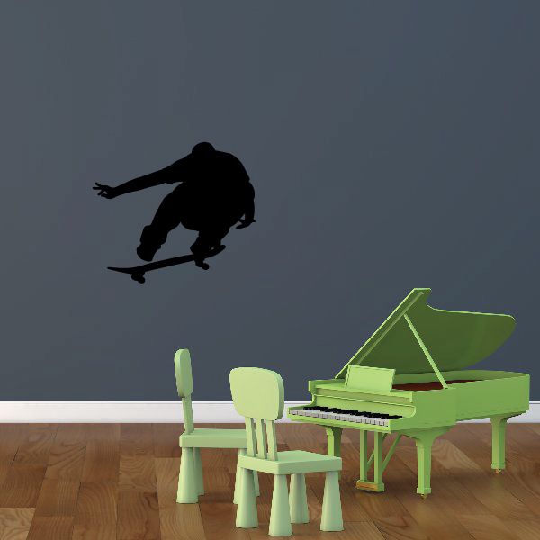 Skateboarding wall decal of a black skateboarder doing an airborne trick