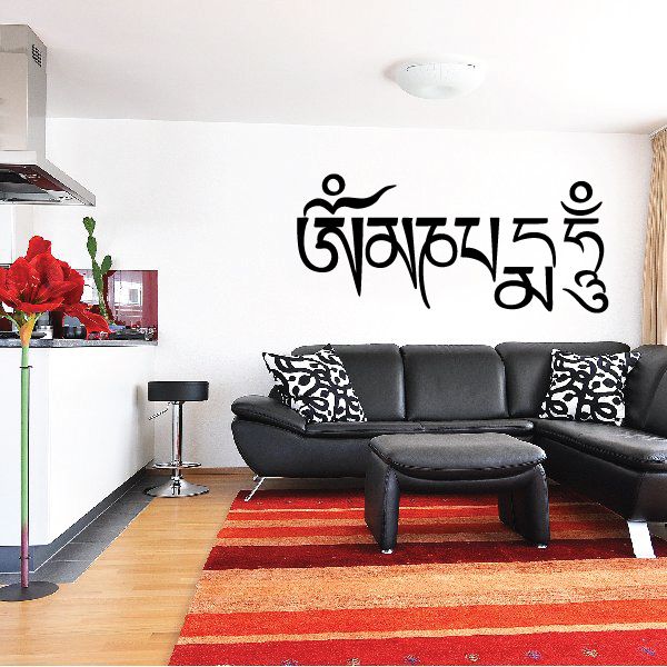 Wall decal with bold black Tibetan script lettering on a light wall