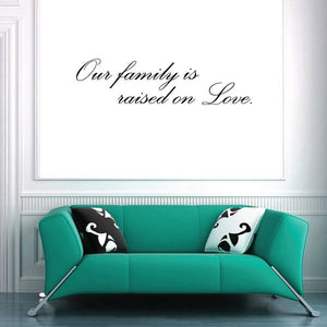 Family wall decal: 'Our family is raised on Love' in script.