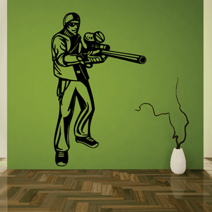 Paintball wall decal of a player holding a marker with speckled smoke trail