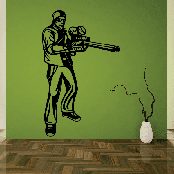 Paintball wall decal of a player holding a marker with speckled smoke trail