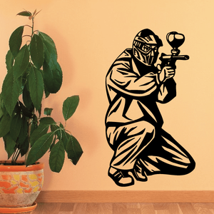 Paintball player vinyl wall decal with black outline holding a marker