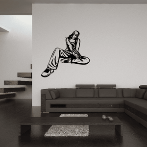 Paintball player wall decal, black vinyl silhouette of a kneeling shooter aiming forward