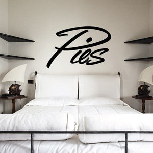 Vinyl wall decal with bold black cursive “Pies” lettering and swoosh