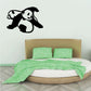Playful pandas decal with two black-and-white pandas on a wall above a bed