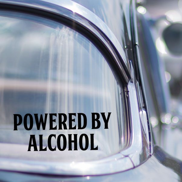 Powered by Alcohol decal with bold black lettering on curved surface