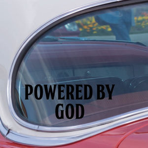 Powered by God decal, bold black text with green outline on window