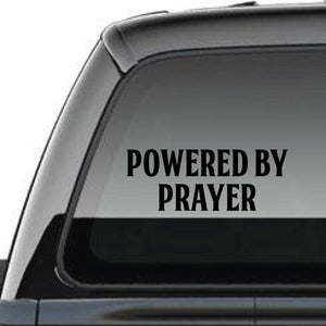 Powered by Prayer window decal with black lettering on light gray surface