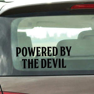 Car window decal with bold black text: POWERED BY THE DEVIL