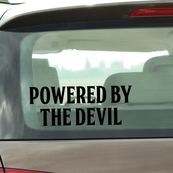 Car window decal with bold black text: POWERED BY THE DEVIL