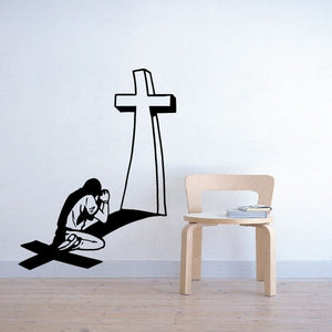 Religious wall decal with kneeling praying figure and large cross outline