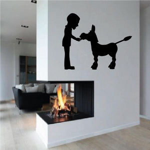 Black silhouette wall decal of a man petting a donkey