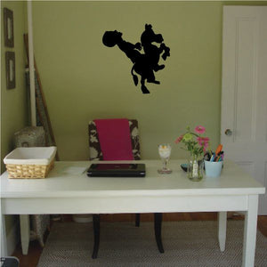 Black silhouette wall decal of a man riding a donkey