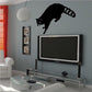 Black raccoon climbing wall decal with paw and tail detail