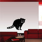 Black sitting raccoon wall decal, facing forward with raised paws