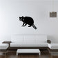 Raccoon sitting decal, black raccoon with striped tail on a light wall